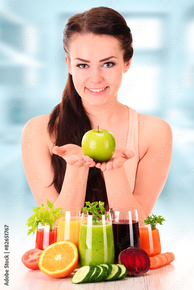 Young woman with variety of vegetable and fruit juices Young woman with variety of vegetable and fruit juices