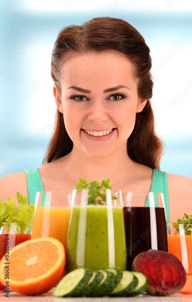 Young woman with variety of vegetable and fruit juices Young woman with variety of vegetable and fruit juices
