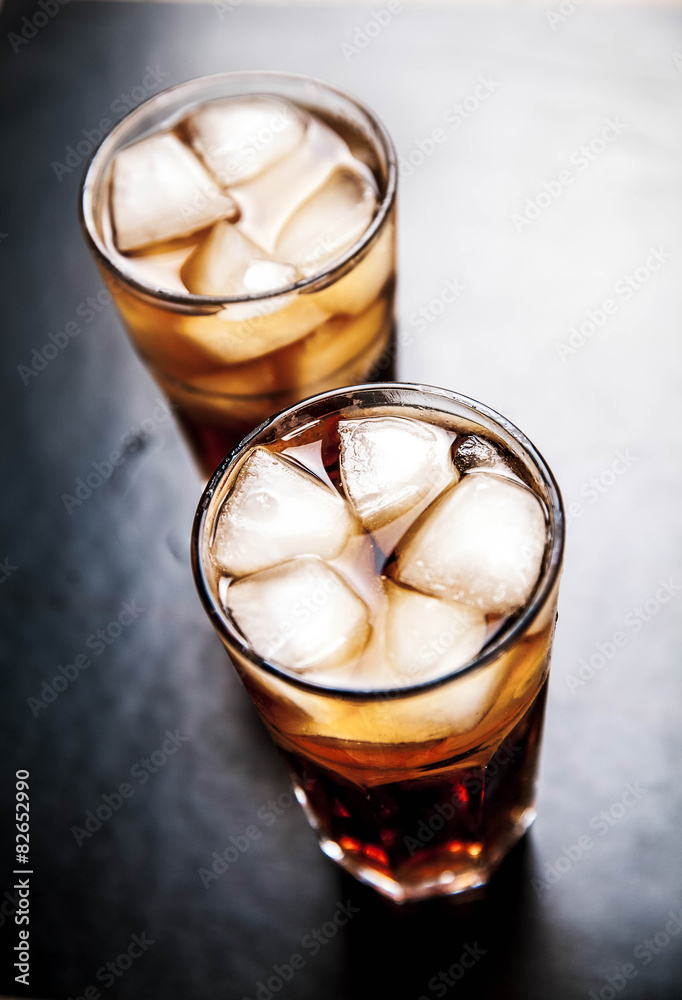 cola with ice on a wooden background. soft drinks cola with ice on a wooden background. soft drinks