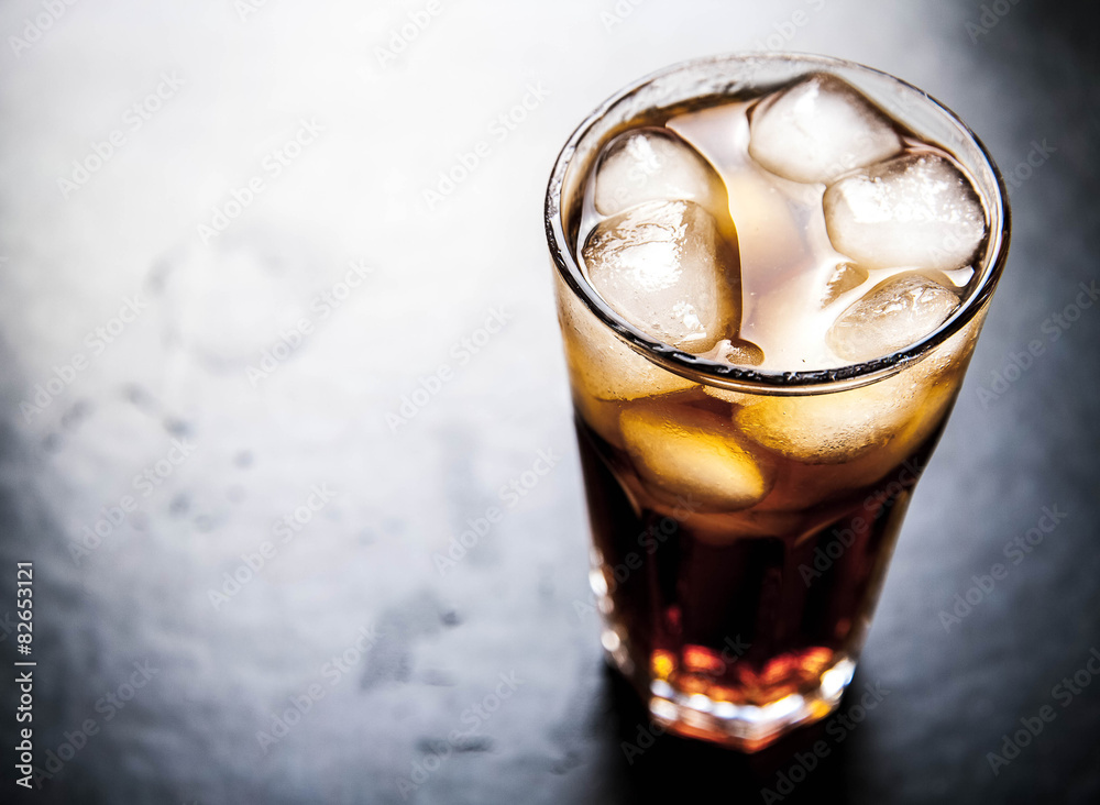 cola with ice on a wooden background. soft drinks cola with ice on a wooden background. soft drinks