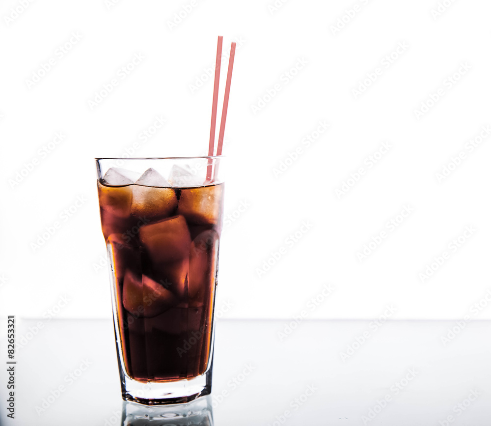 Cola in a glass with ice with red tube. soft drinks Cola in a glass with ice with red tube. soft drinks