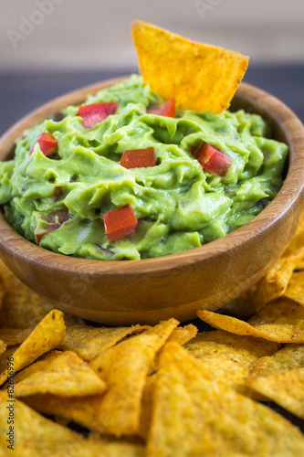 Guacamole in Wooden Bowl with Tortilla Chips