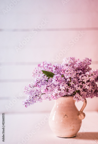 Bouquet of lilacs on wooden background