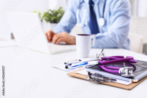 Male doctor sitting at his desk
