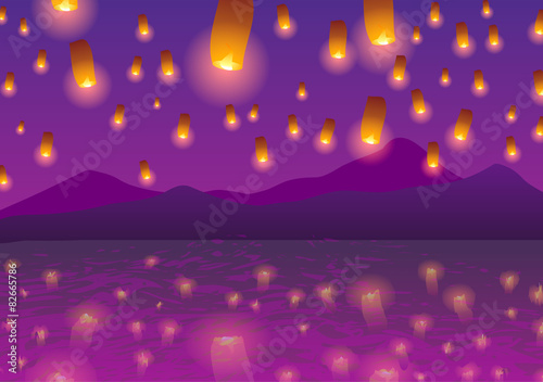 Sky lanterns at sunset over the water.