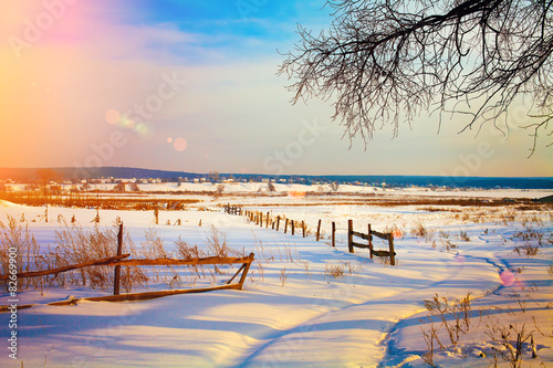 Beautiful rural landscape at sunset in snowy winter © vvvita