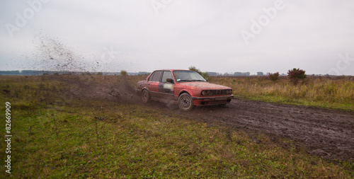 Red sport car drive on the dirt