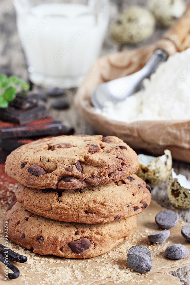 Chocolate cookies with chocolate chips on a rustic wooden table