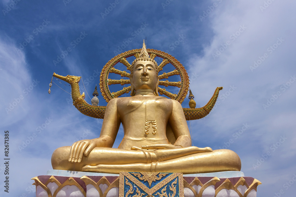 Fototapeta premium Golden Buddha statue in Thailand with blue sky background