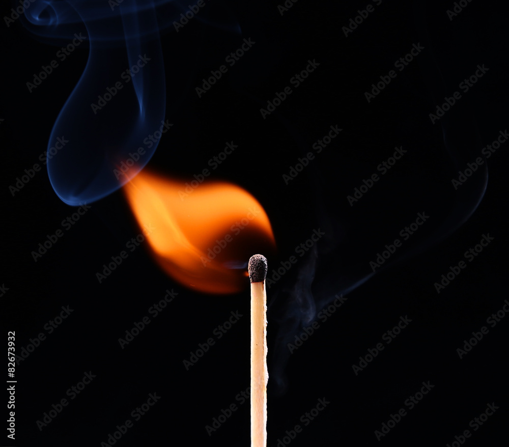 Ignition of a match, with smoke on dark background Ignition of a match, with smoke on dark background
