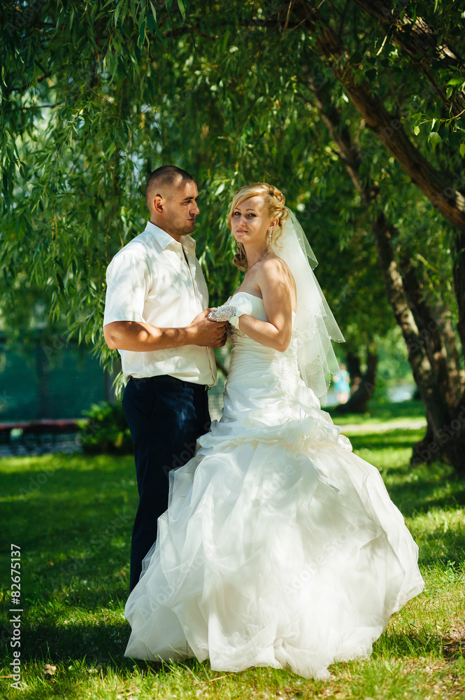 Bride with Groom at wedding Day walking Outdoors on spring Bride with Groom at wedding Day walking Outdoors on spring