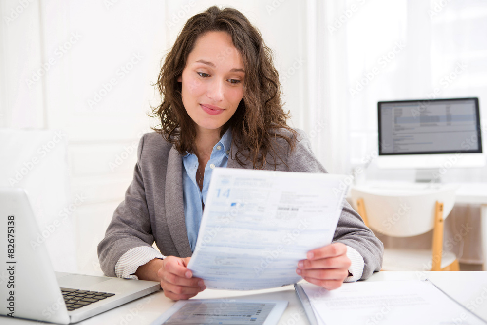 Young attractive woman doing paperwork