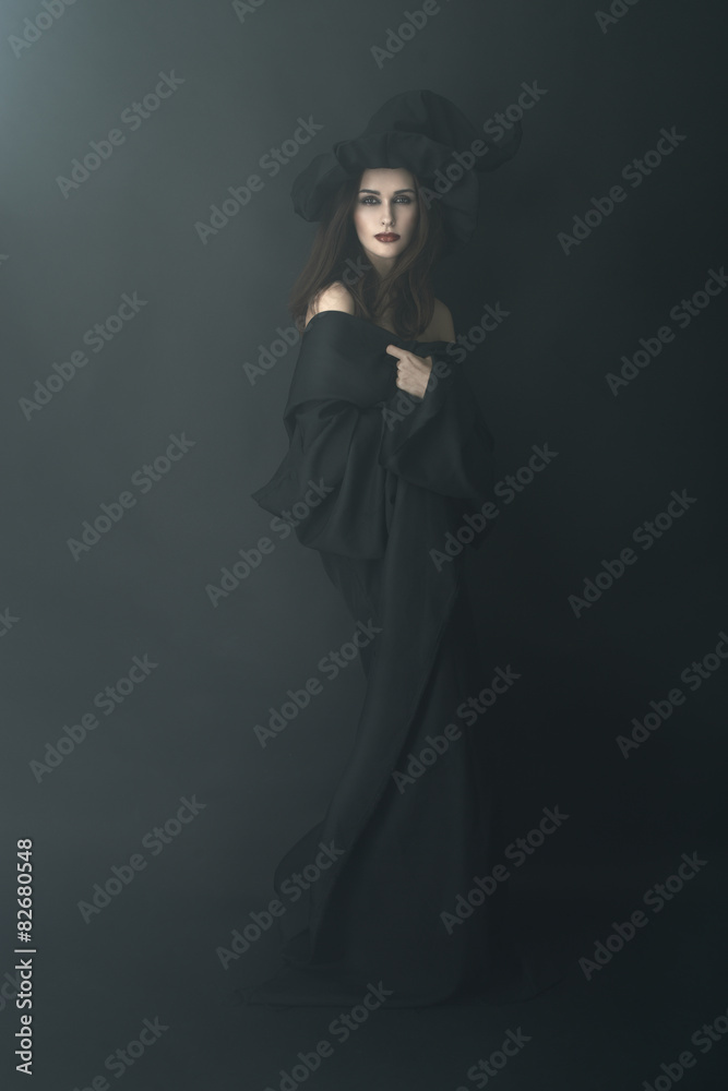 slender witch in a dark fog