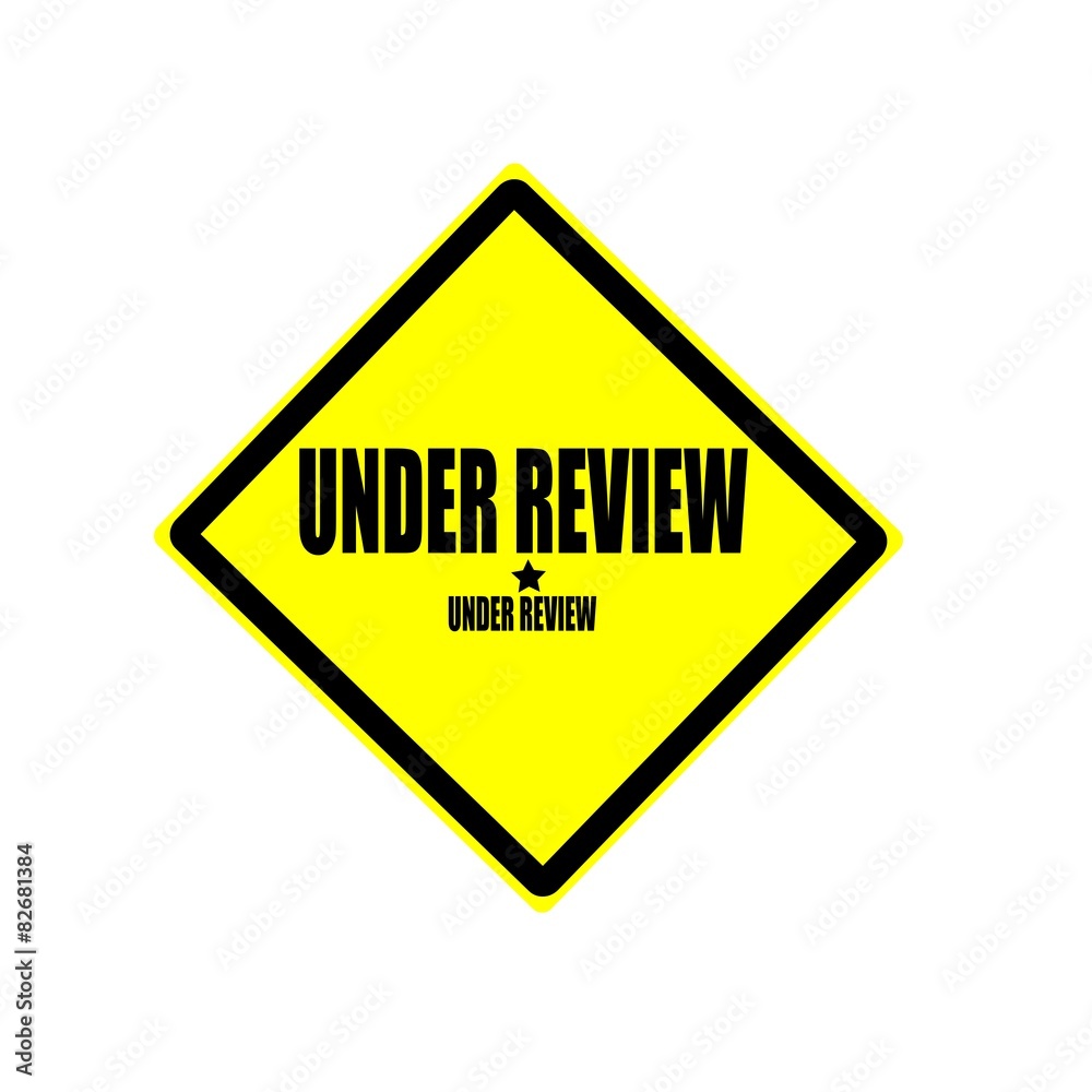 Under review black stamp text on yellow background Under review black stamp text on yellow background