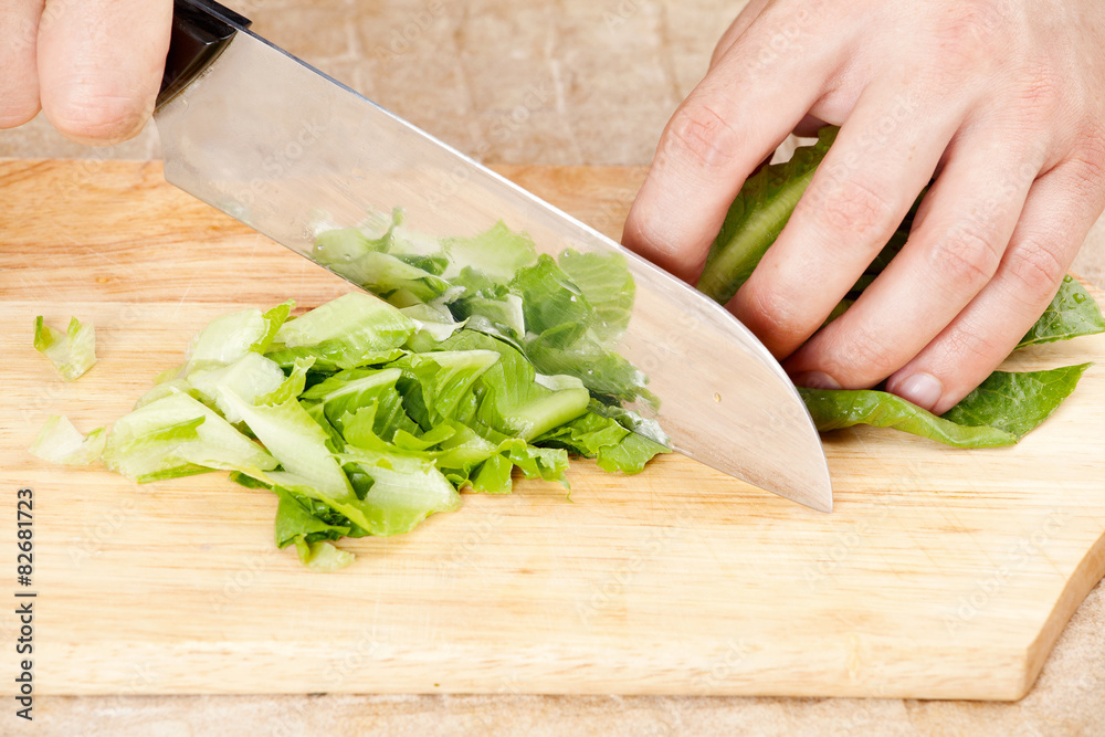 Cook cuts the lettuce Cook cuts the lettuce