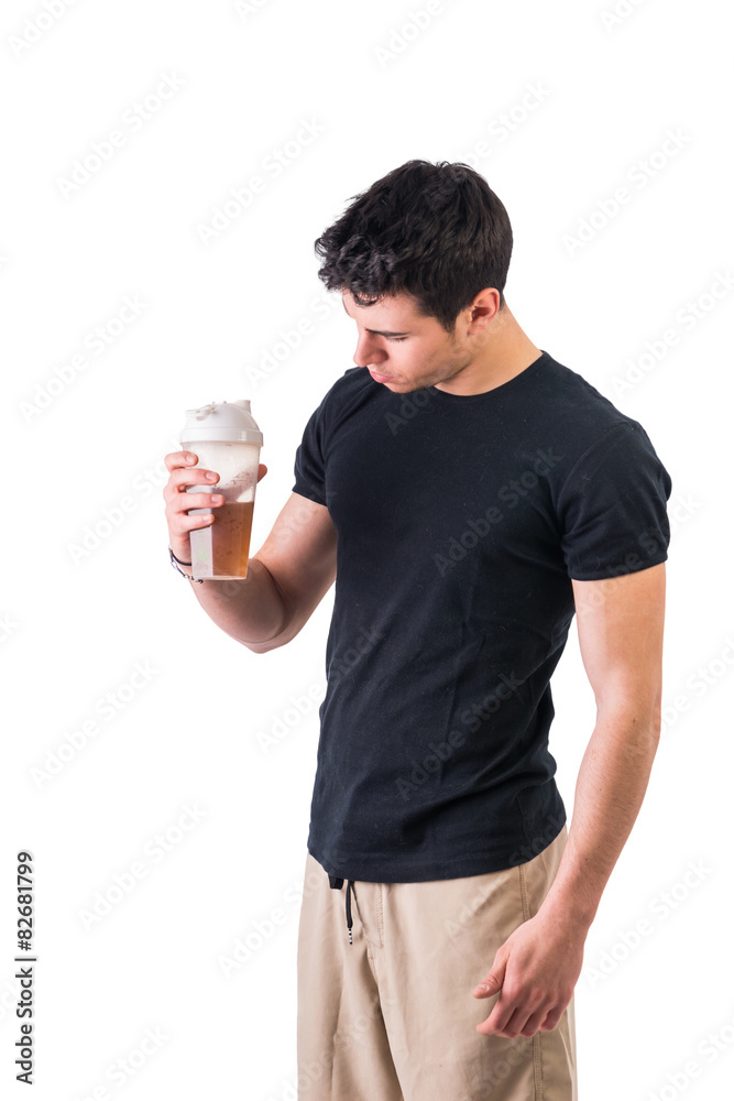 Attractive young man holding protein shake bottle Attractive young man holding protein shake bottle