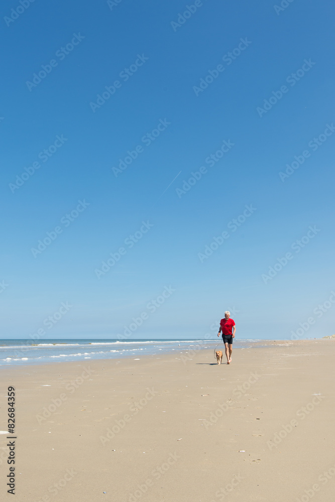 Running with dog at the beach