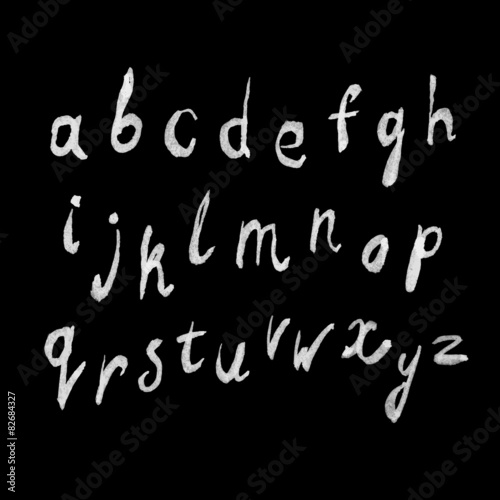 White paint hand-drawn alphabet on blackboard