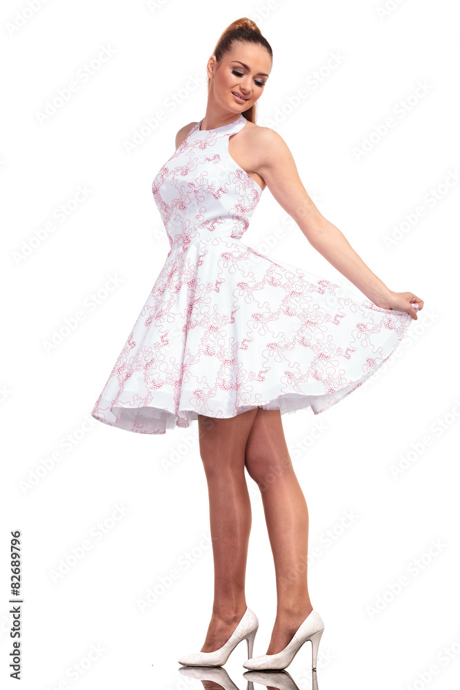 Smiling young fashion woman looking down Smiling young fashion woman looking down