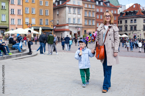 Mam and son walking in old town Warsaw, Poland