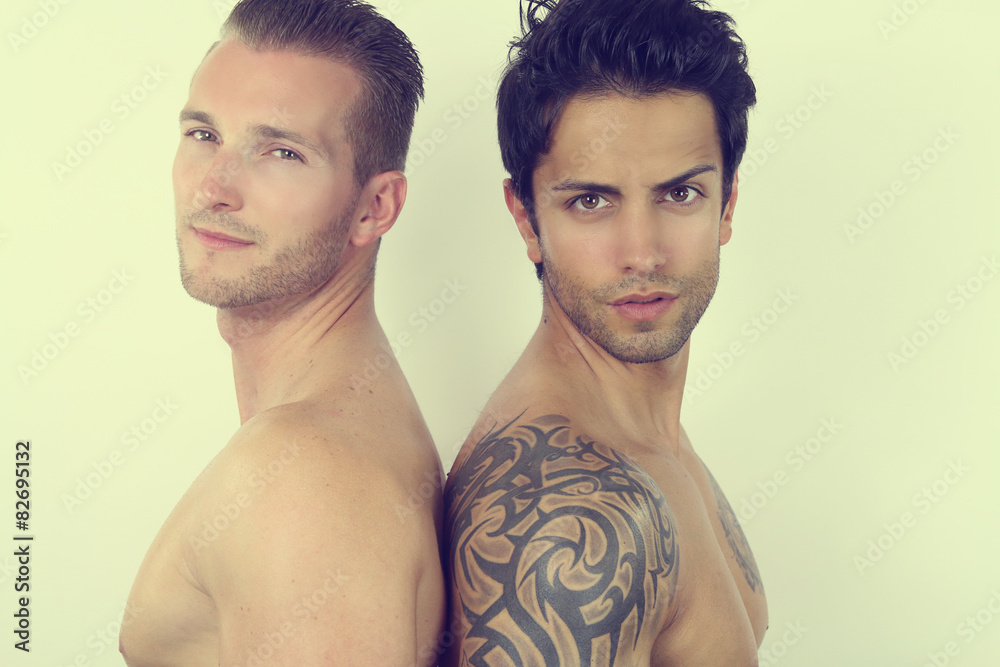 Stockfoto med beskrivningen two handsome men posing back to back