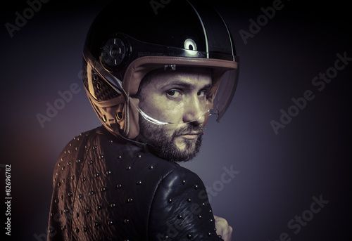 biker with motorcycle helmet and black leather jacket, metal stu © Fernando Cortés