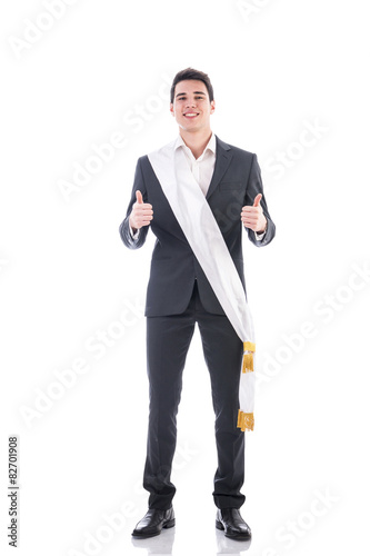 Young elegant man wearing winning ribbon or sash photo