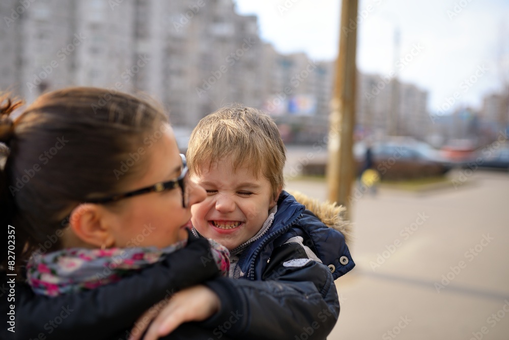 The happy child laughs on mother's hands The happy child laughs on mother's hands