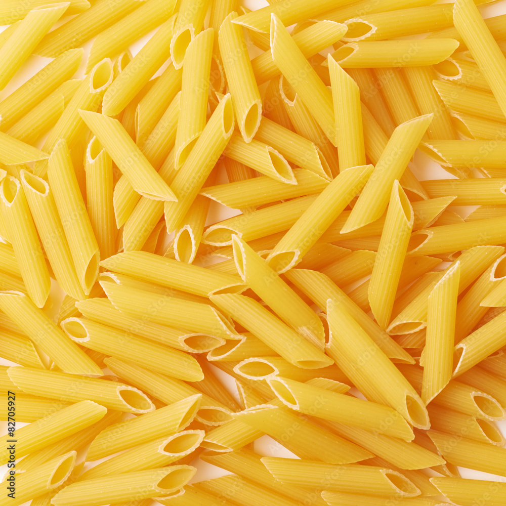 Surface covered with penne pasta Surface covered with penne pasta