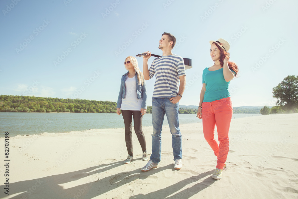 Group of young friends walking on the beach Group of young friends walking on the beach