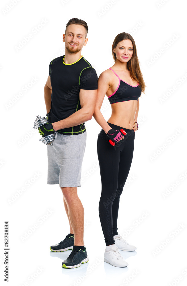 Sport couple - man and woman with dumbbells on the white Sport couple - man and woman with dumbbells on the white