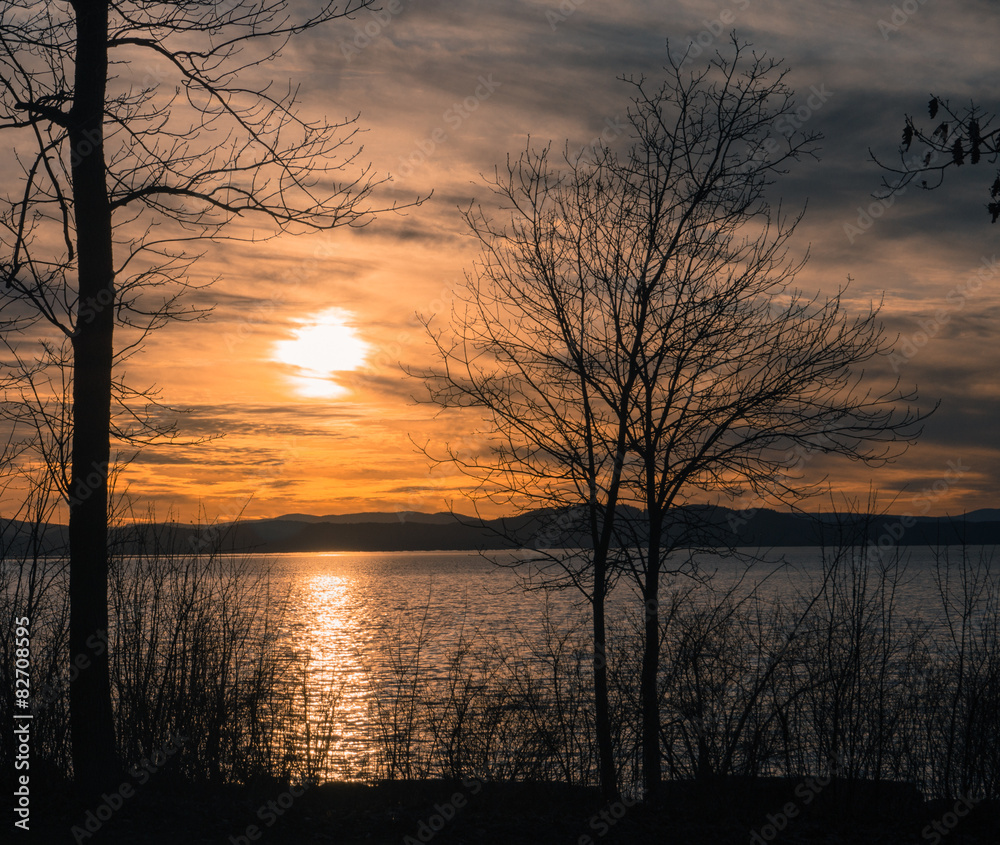 sun setting with reflection on lake sun setting with reflection on lake
