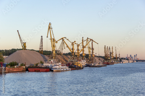 barges and cranes in river port photo