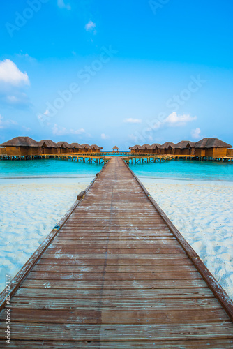 Over water bungalows with steps into amazing green lagoon © theyok