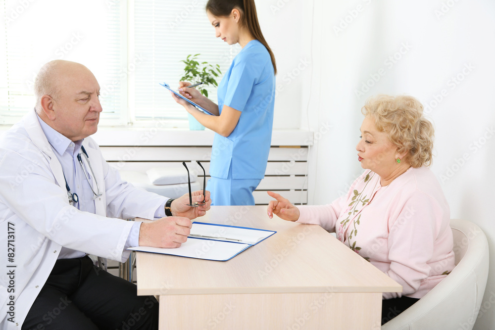 Happy doctors and patient in hospital clinic Happy doctors and patient in hospital clinic