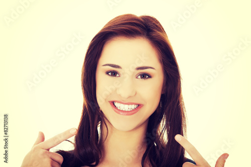 Young woman showing her teeth