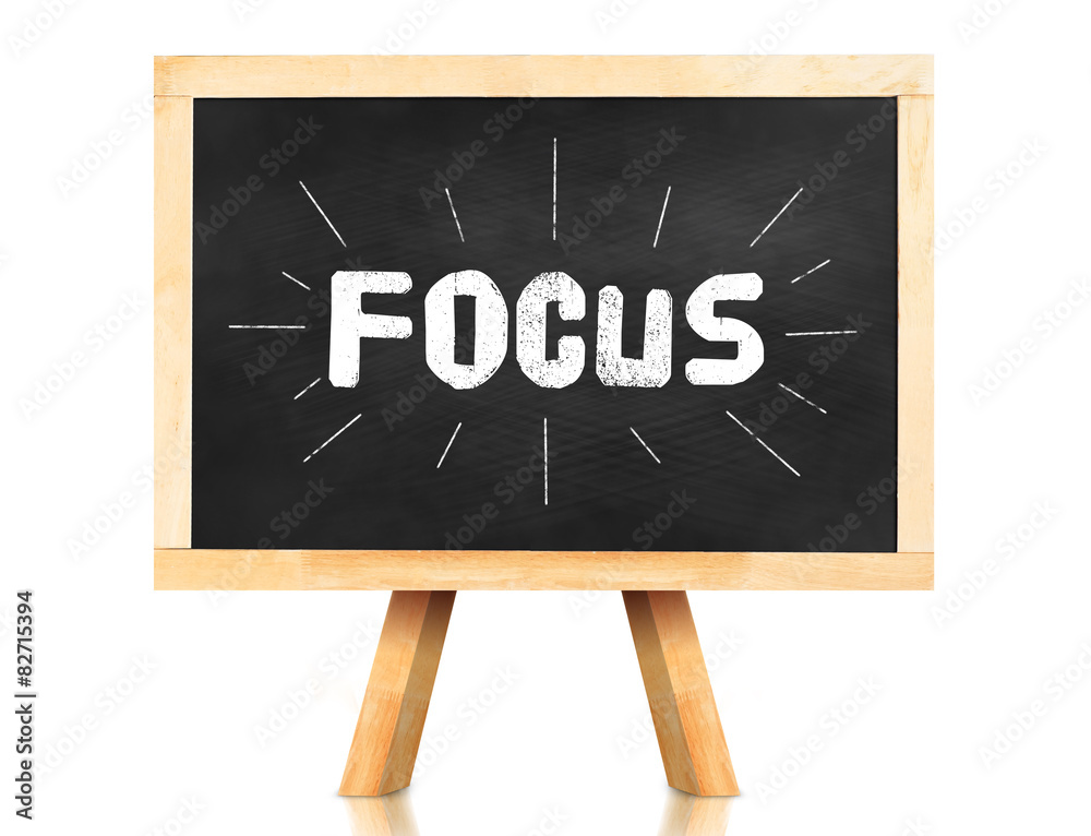 Focus word with emphasis line on blackboard with easel and refle
