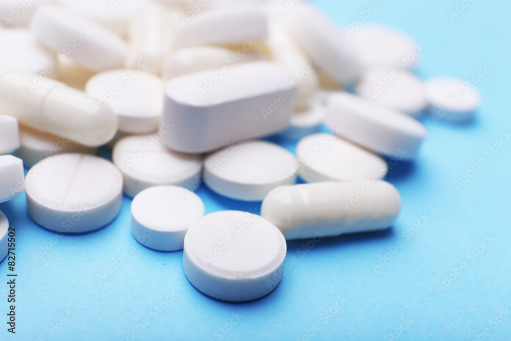 Pile of pills on color table, closeup Pile of pills on color table, closeup