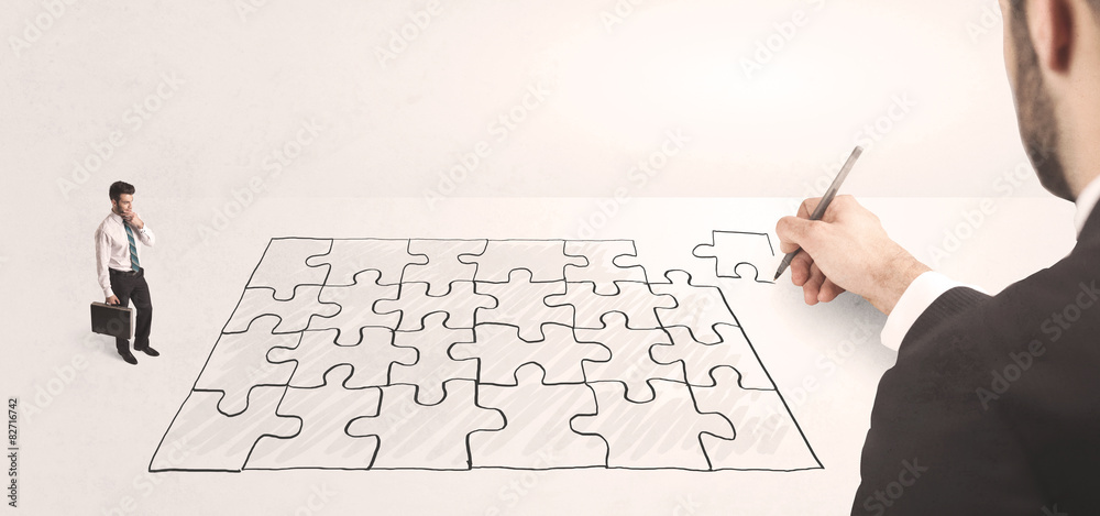 Business man looking at hand drawing solution Business man looking at hand drawing solution