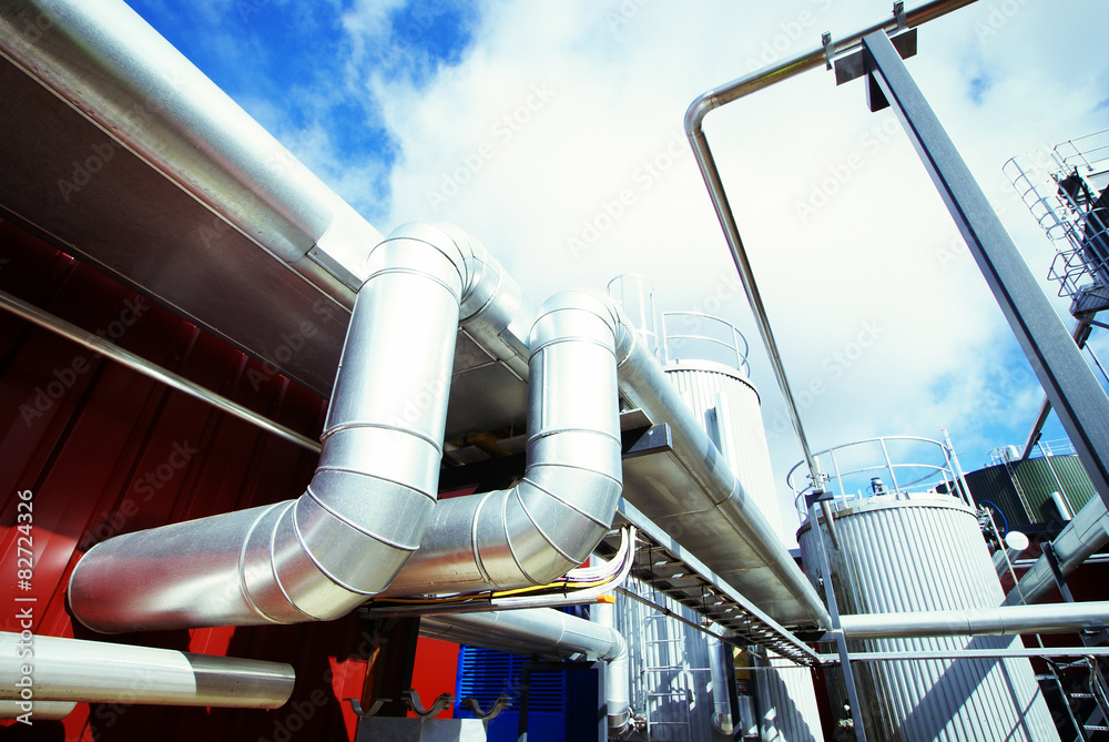 Industrial zone, Steel pipelines and valves against blue sky