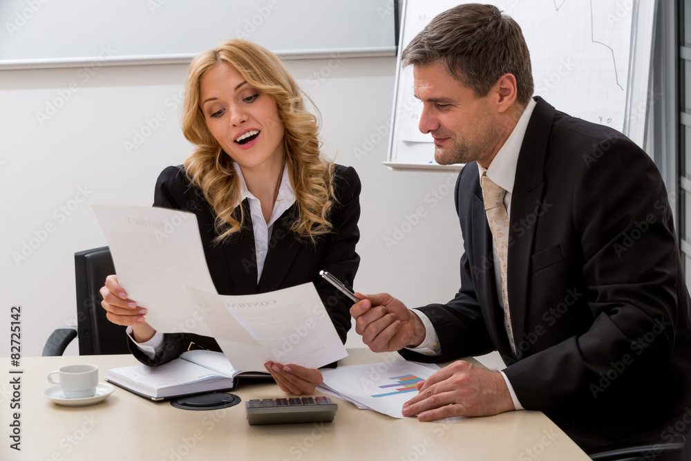 Two clerks in the office. Two clerks in the office.