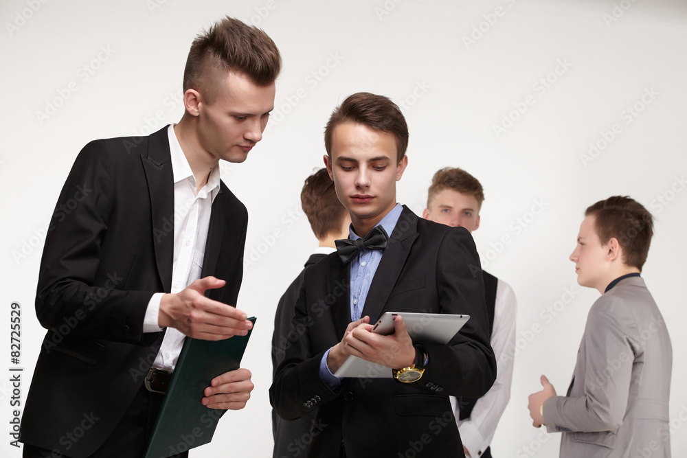 a group of young businessmen looking at paperwork a group of young businessmen looking at paperwork
