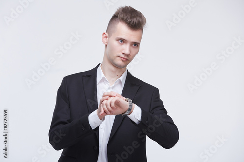 businessman in a suit looking at his watch