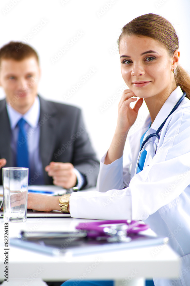 Medical team sitting at the table in modern hospital Medical team sitting at the table in modern hospital