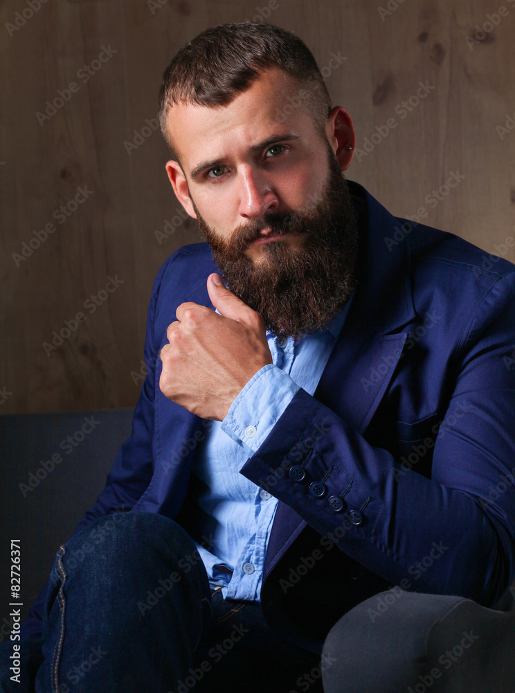 Fototapeta premium Businessman sitting on sofa in office lobby