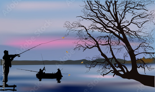 fishermen and large tree silhouette at sunset