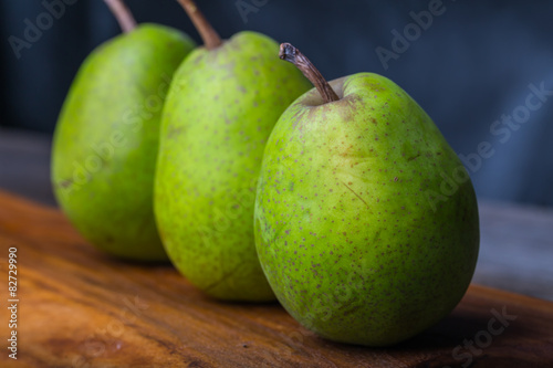 Pears on wooden cutting board and ancient wooden table