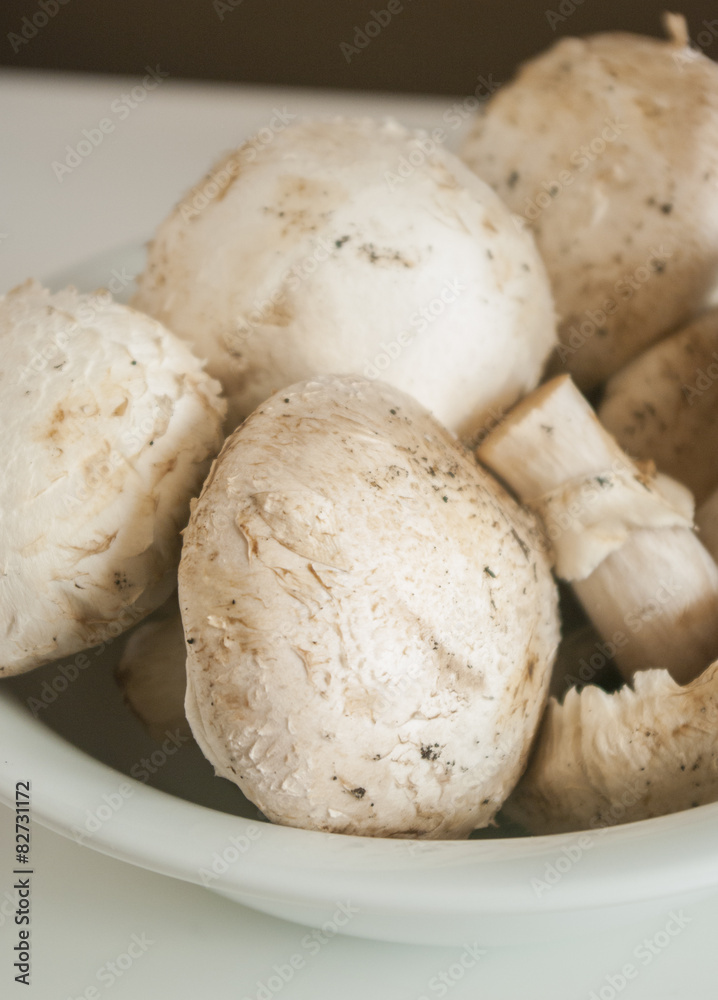 Heap of champignon mushrooms. Isolated on white background Heap of champignon mushrooms. Isolated on white background