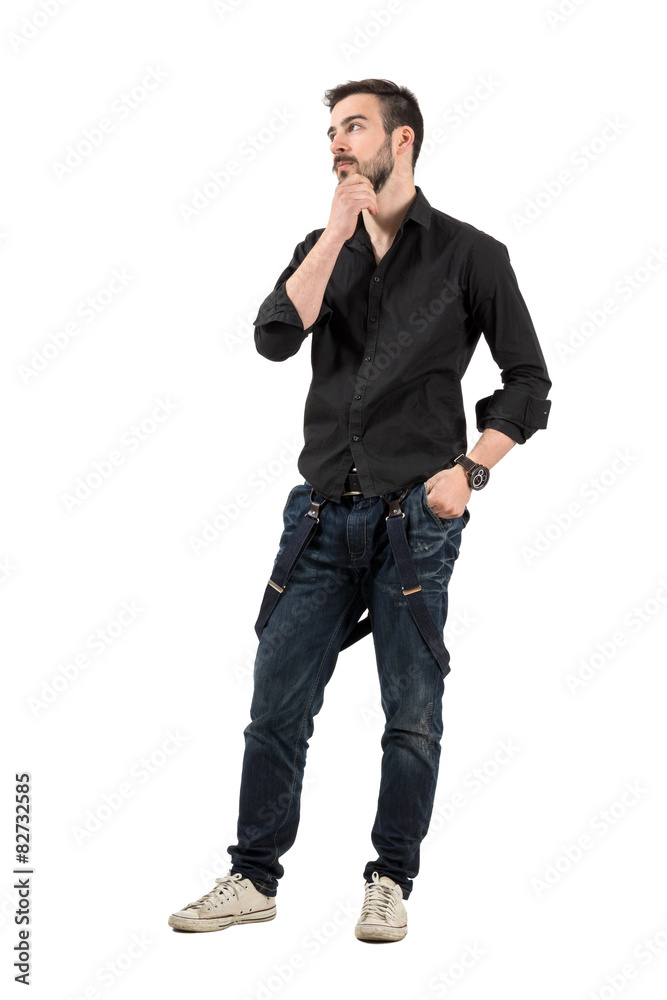 Young cool trendy man touching his beard looking away. Young cool trendy man touching his beard looking away.