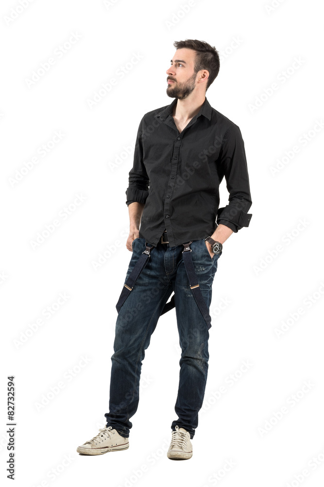 Serious young man with hands in pocket looking up Serious young man with hands in pocket looking up